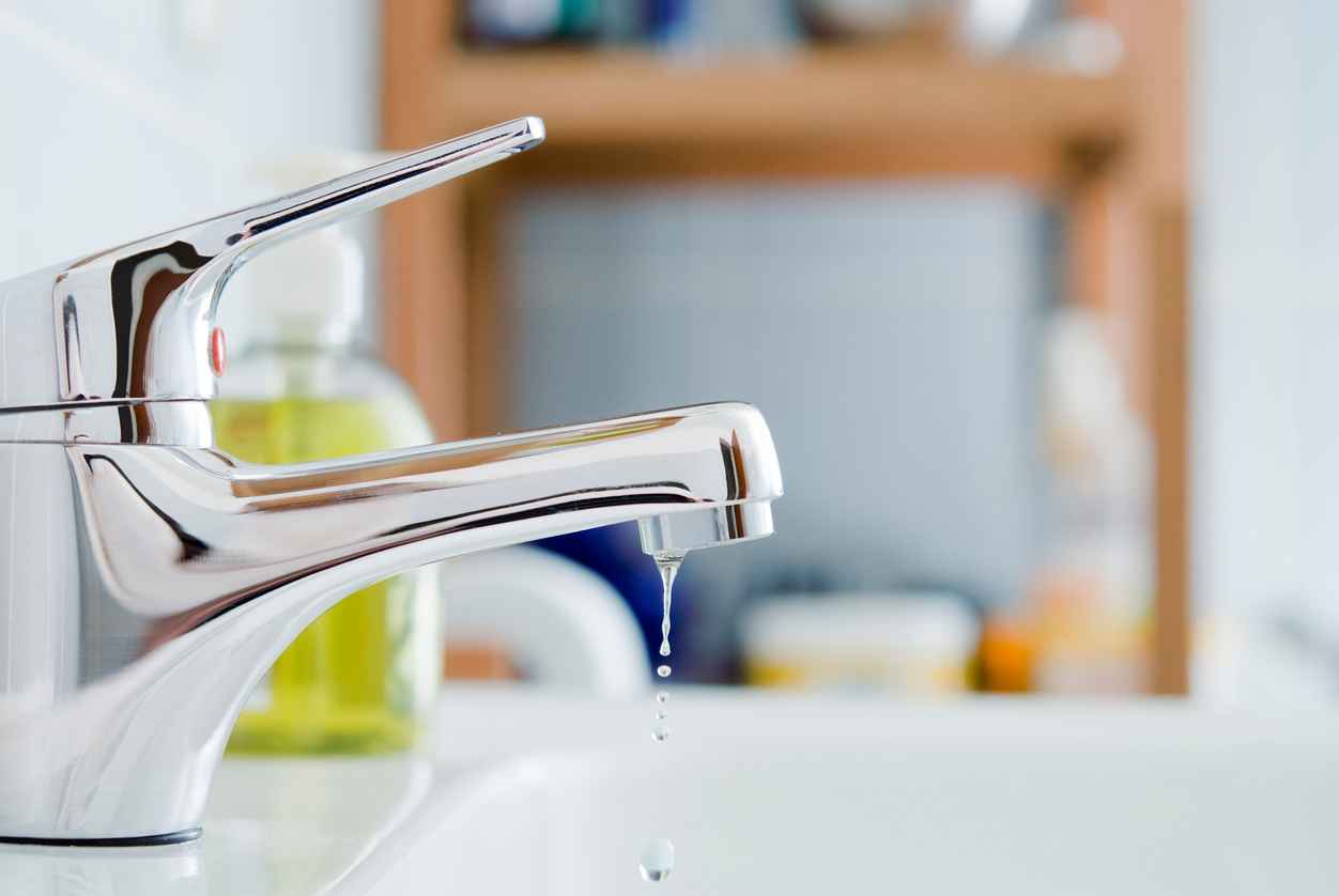 A dripping faucet in a residential bathroom