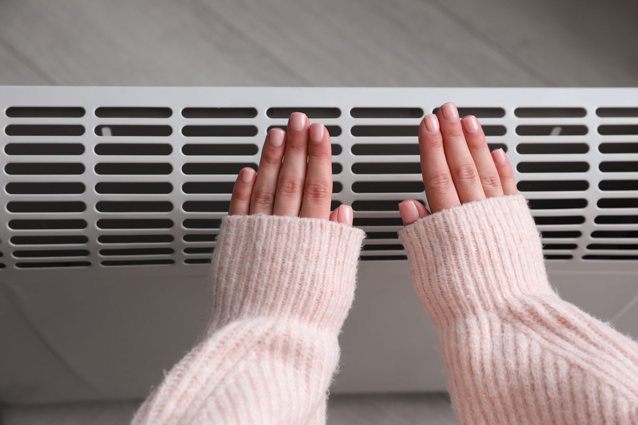 Hands in Front of Heater